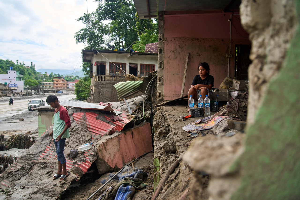 A girl sits in a building damaged by the recent flash floods, in Dhading District, Nepal, Sunday. (AP-Yonhap)