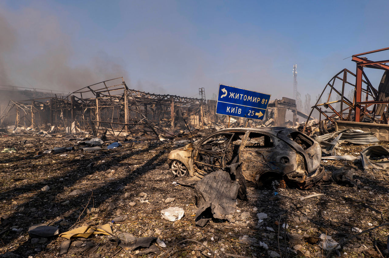 A view of a destroyed car amid damaged buildings in Kyiv, Ukraine, Saturday. (AP-Yonhap)