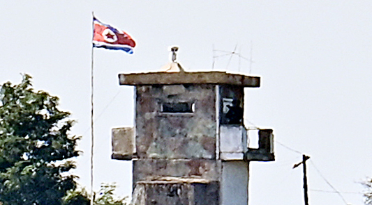 A North Korean flag flies at a guard post visible from the border area in Paju, Gyeonggi Province, on Aug. 18. (Lee Sang-sub)