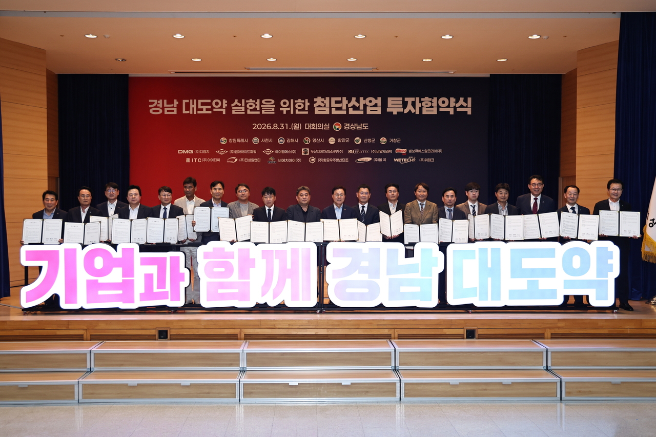 박완수 도지사(앞줄 왼쪽 10번째)와 12개 첨단산업 기업 대표들이 31일 도청 대회의실에서 열린 투자협약식에서 협약서를 들어 보이며 기념촬영을 하고 있다. [경남도 제공]