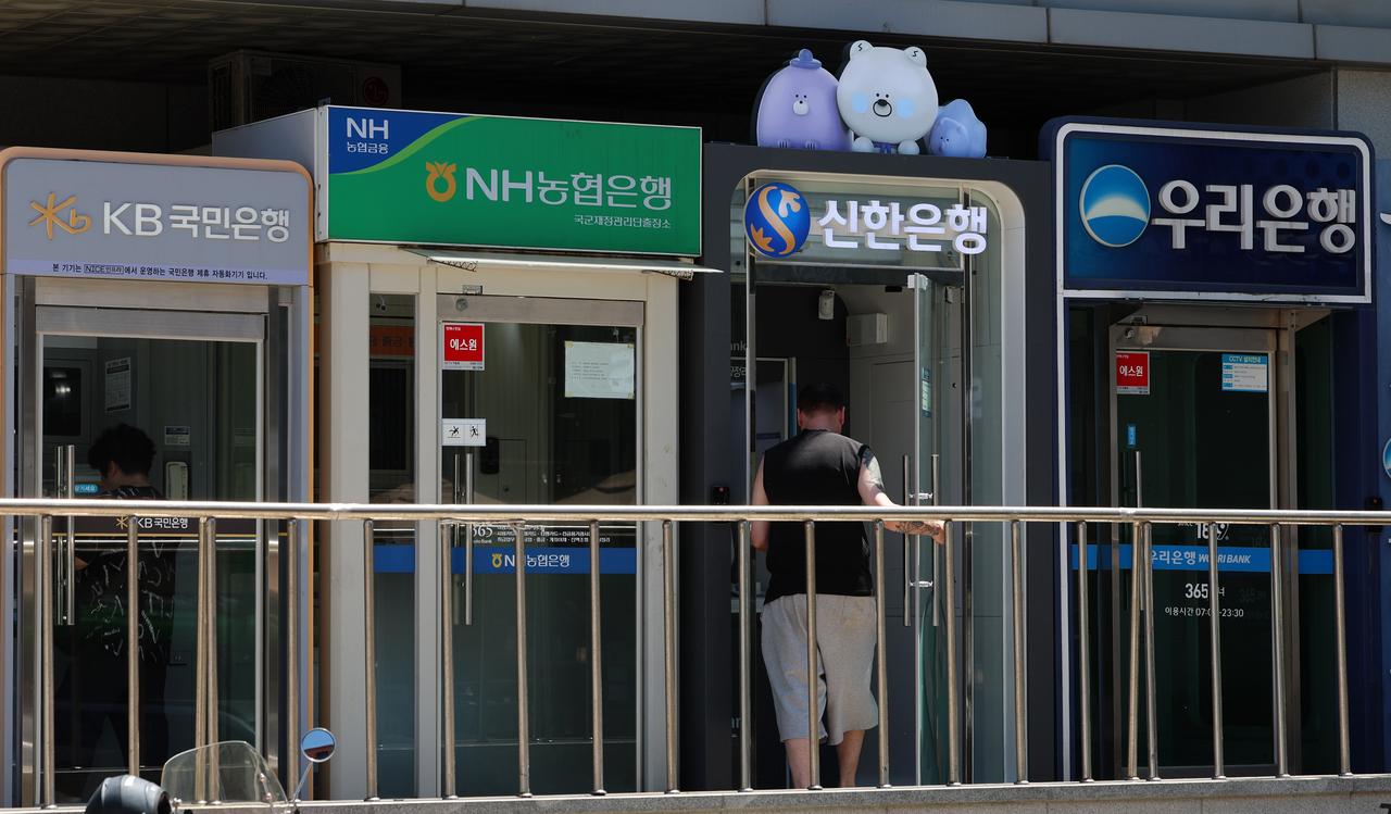 ATMs from major banks are clustered in a building in Seoul. [Newsis]