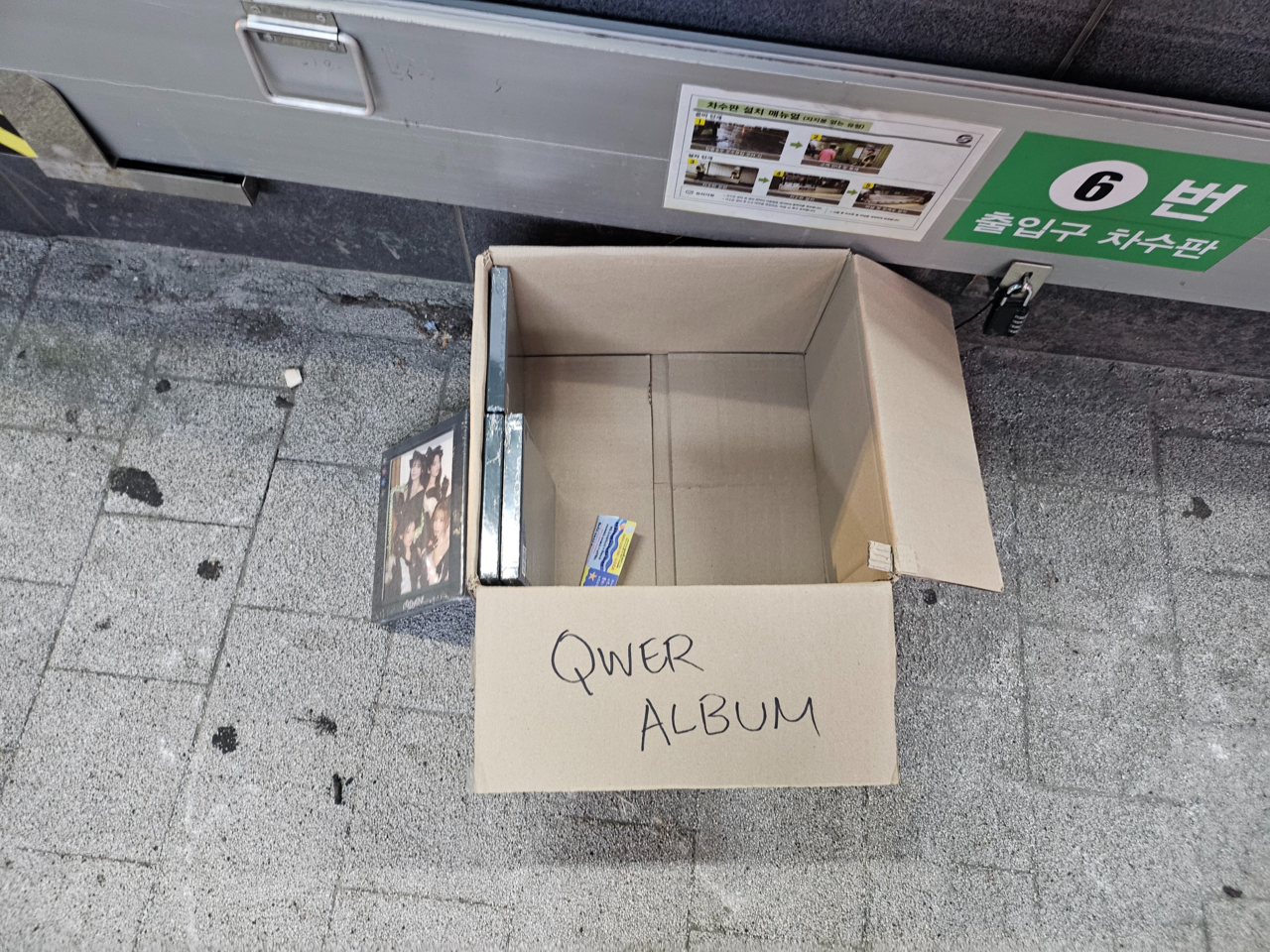 Boxes of K-pop albums left outside an exit of Ewha Womans University Station on Seoul Metro Line 2. (Kim Gwang-woo)