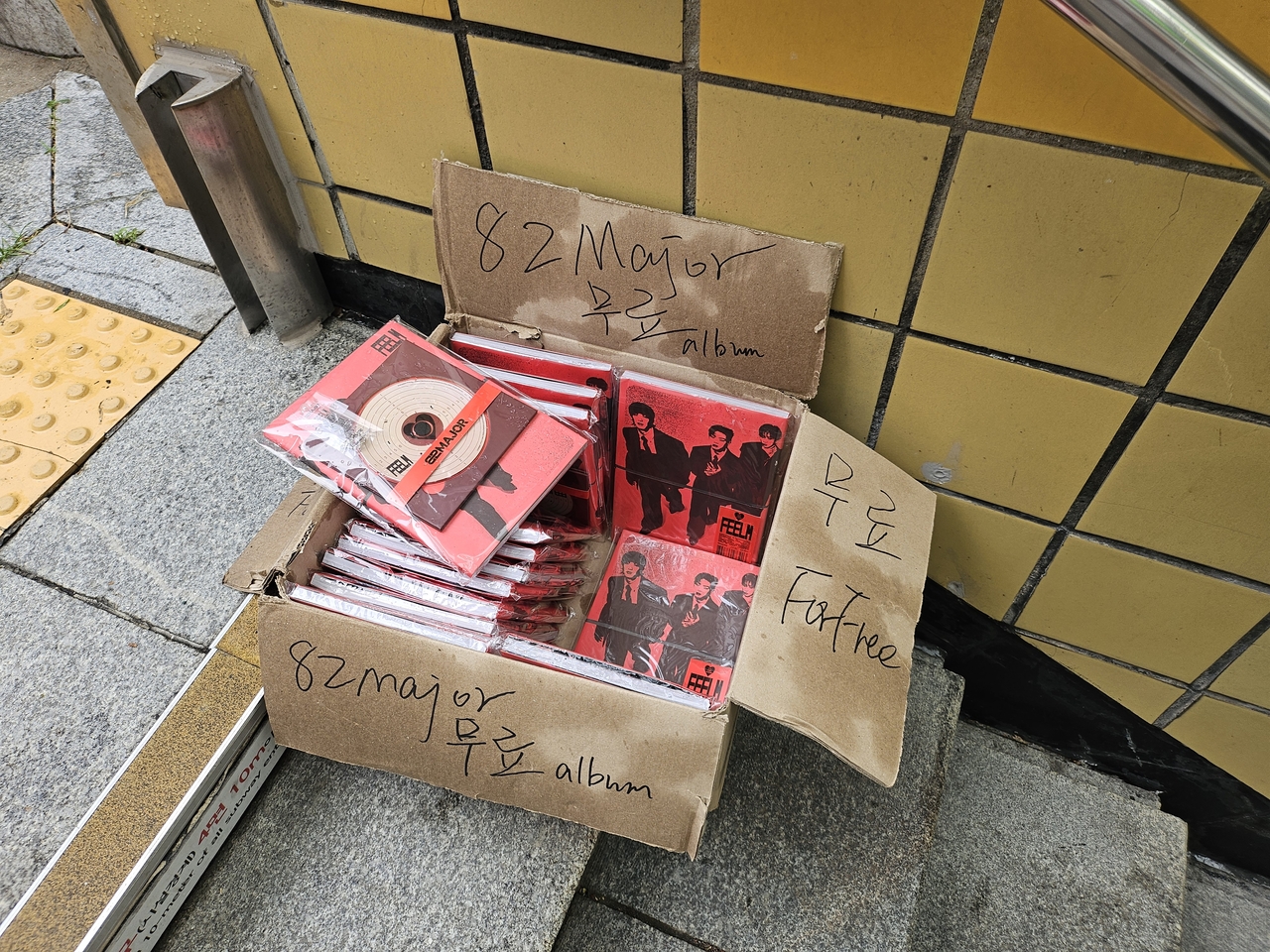 Boxes of K-pop albums left outside an exit of Ewha Womans University Station on Seoul Metro Line 2. (Kim Gwang-woo)