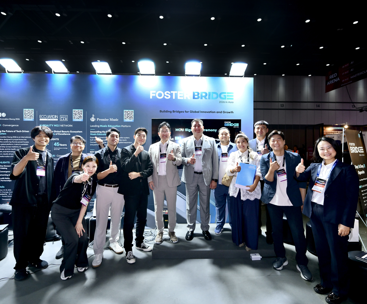 Representatives from South Korea and Kazakhstan pose for a photo after signing a memorandum of understanding at the Fosterbridge booth during the Techsauce Global Summit 2026 at the Queen Sirikit National Convention Center in Bangkok, Thailand, on Thursday (local time). [Fosterbridge]