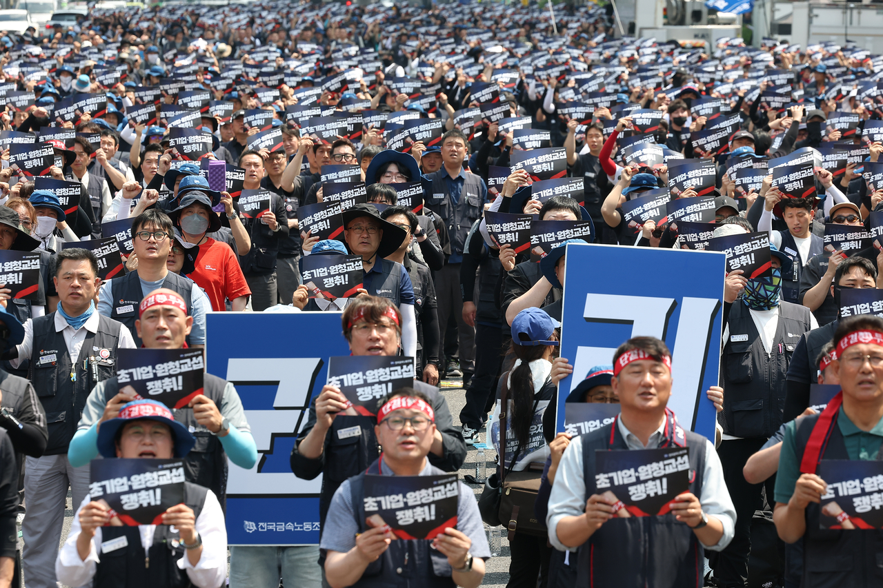 Participants hold placards and flags at a rally of 10,000 Korean Metal Workers' Union officials near Gwanghwamun Square in Jongno-gu, Seoul, on June 10, amid ongoing confusion at industrial sites following the implementation of the yellow envelope law. [Yonhap]