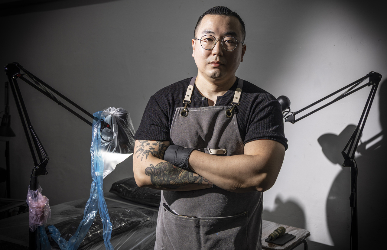 Tattooist Choi Hae-sol poses at his studio in Gwangjin-gu, Seoul, ahead of an interview with The Korea Herald on Aug. 11. (Yoon Chang-bin/The Korea Herald)