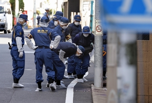 Japanese police investigate the scene where a South Korean woman was found dead following an attack in Tokyo's Setagaya Ward on Sept. 1, 2025. (Yonhap)
