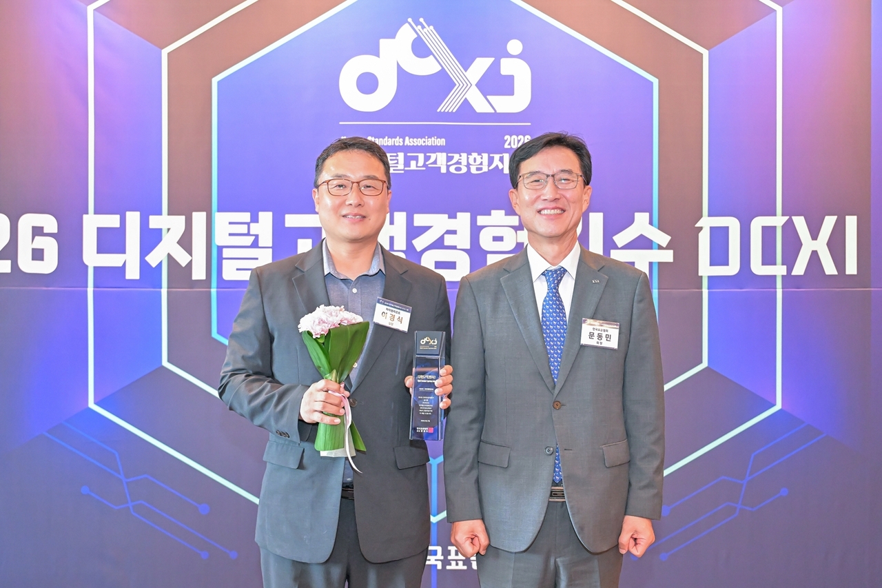 Lee Kyung-sik, head of AI and digital innovation at Kangwon Land, and Korean Standards Association President Moon Dong-min attend the 2026 Digital Customer Experience Index awards ceremony for the resort category at Seoul Shilla Hotel on Aug. 27. [Kangwon Land]