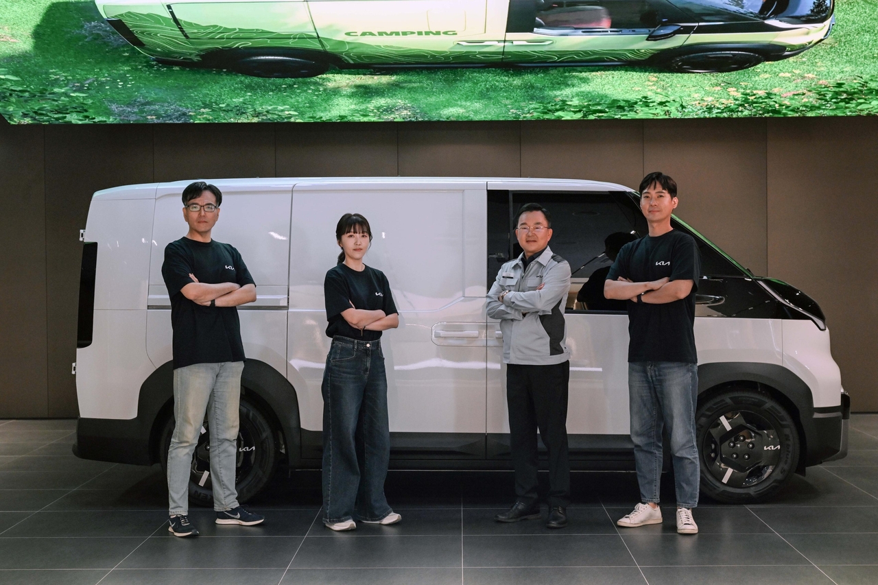 From left, Kim Min-su, team leader of the PBV Conversion Operations Team; Lee Si-young, senior manager of the PBV Conversion Development Team; So Deuk-young, executive director and plant manager of Autoland Hwaseong; and Seong Si-young, senior manager of the Manufacturing Planning Team, pose for a photo at Kia's PBV production hub tech day on Tuesday. (Kia)