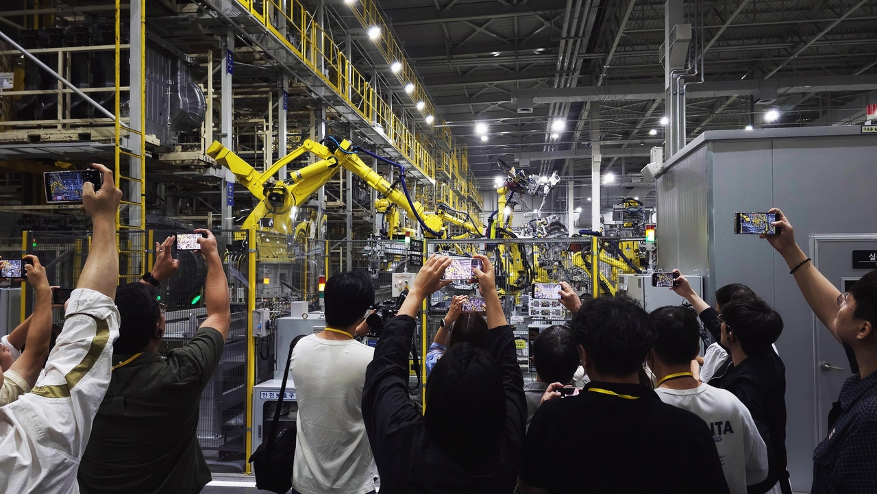 Participants tour the body shop at Kia's Hwaseong EVO Plant during a PBV production hub tech day on Tuesday. (Kia)
