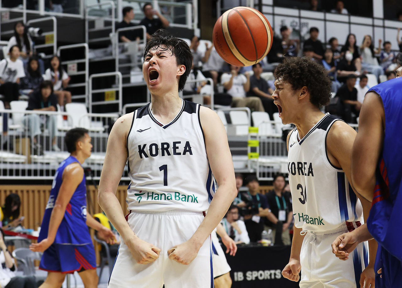 Lee Hyun-jung of South Korea (L) celebrates after getting fouled on a made basket to set up a three-point play during a men's basketball exhibition game against the Philippines at KT Sonicboom Arena in Suwon, Gyeonggi Province, on Friday. (Yonhap)