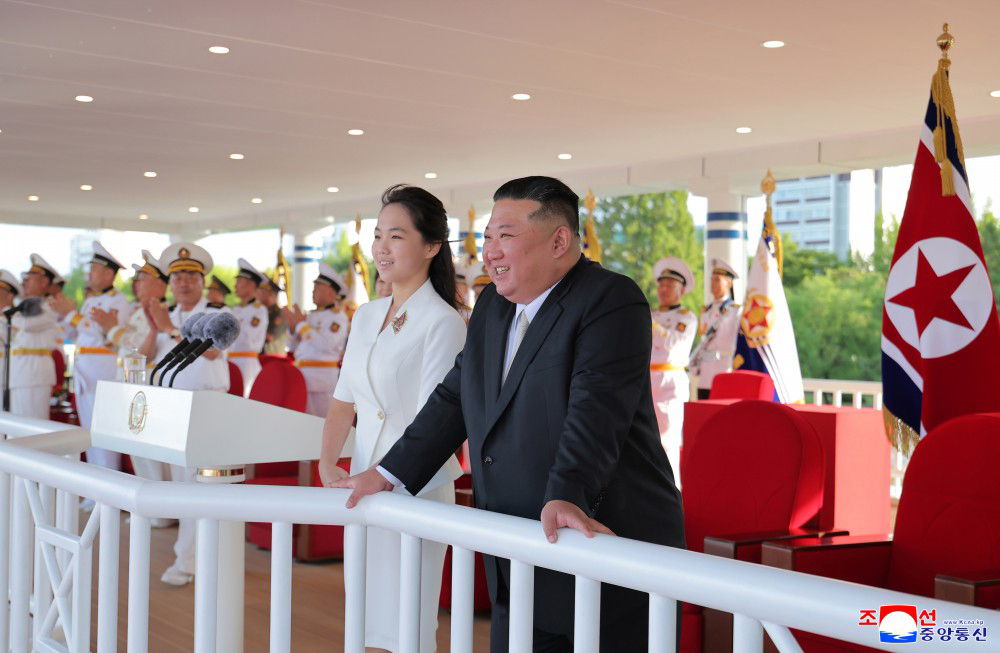 North Korean leader Kim Jong-un (right) and his daughter Ju-ae attend a commissioning ceremony for the new naval destroyer Kang Kon at Wonsan Port on Sunday, in this photo released by the Korean Central News Agency the following day. (KCNA-Yonhap)