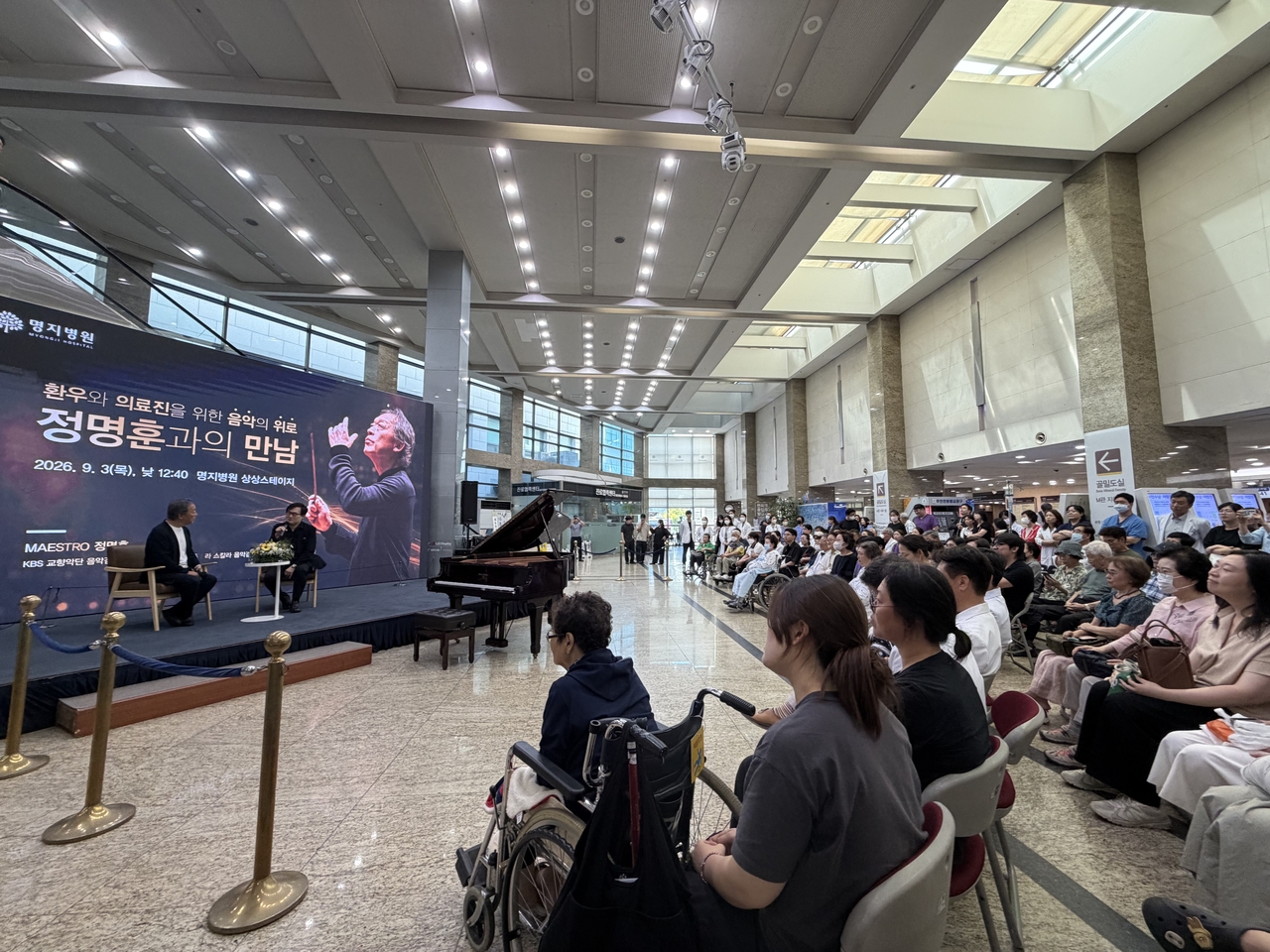Conductor Chung Myung-whun and classical music columnist and thoracic surgeon Yoo Jung-woo talk in front of patients and staff at Myongji Hospital in Goyang, Gyeonggi Province, on Sept. 3. (Park Ga-young/The Korea Herald)