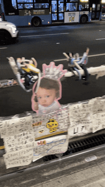 Fan-made dolls depicting HYBE artists fill pedestrian railings outside the company’s headquarters in Yongsan-gu, Seoul. (Tammy Park/The Korea Herald)