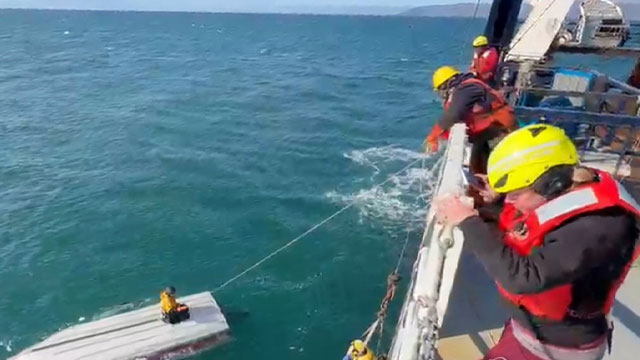 Crew members rescue a 15-year-old boy adrift in a remote stretch of the Bering Sea off Alaska. [AP]