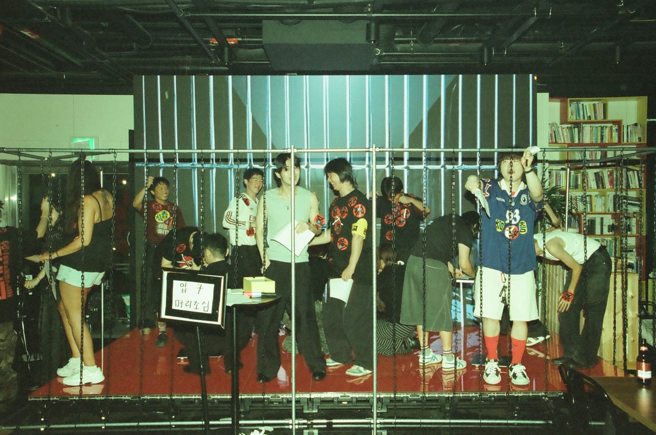 Participants are locked in a mock jail after being caught dancing during "Party Where You Can’t Dance,” in Jeonju on Sept. 5. (Courtesy of Urban Strikers’ Jeonju branch)