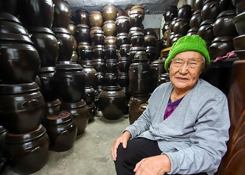 Hanshin Onggi founder Shin Yeon-geun sits surrounded by onggi at her shop in Haebangchon, Yongsan-gu, Seoul. (Hanshin Onggi)