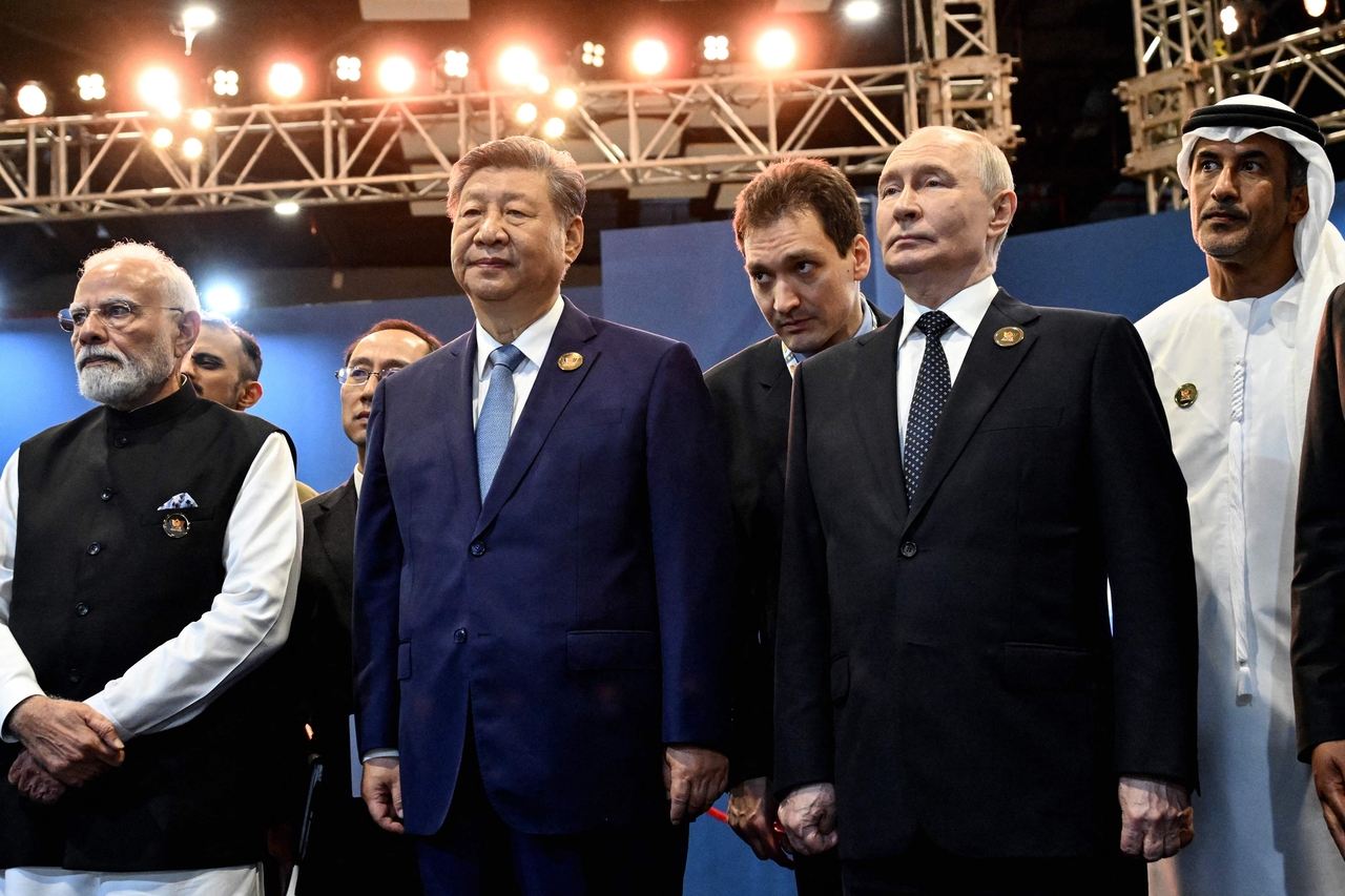 Indian Prime Minister Narendra Modi (front row, from left), Chinese President Xi Jinping and Russian President Vladimir Putin stand together at the 18th BRICS Summit in New Delhi, India, on Saturday. [AFP]