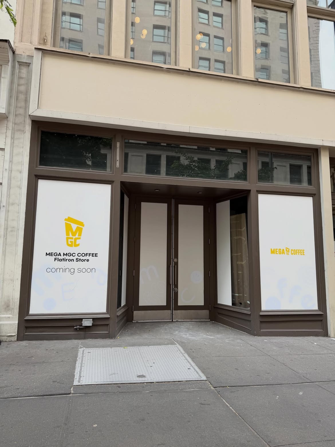 Signage for Mega MGC Coffee on a storefront window near the Flatiron Building in Manhattan (@gramercy_local, Instagram)