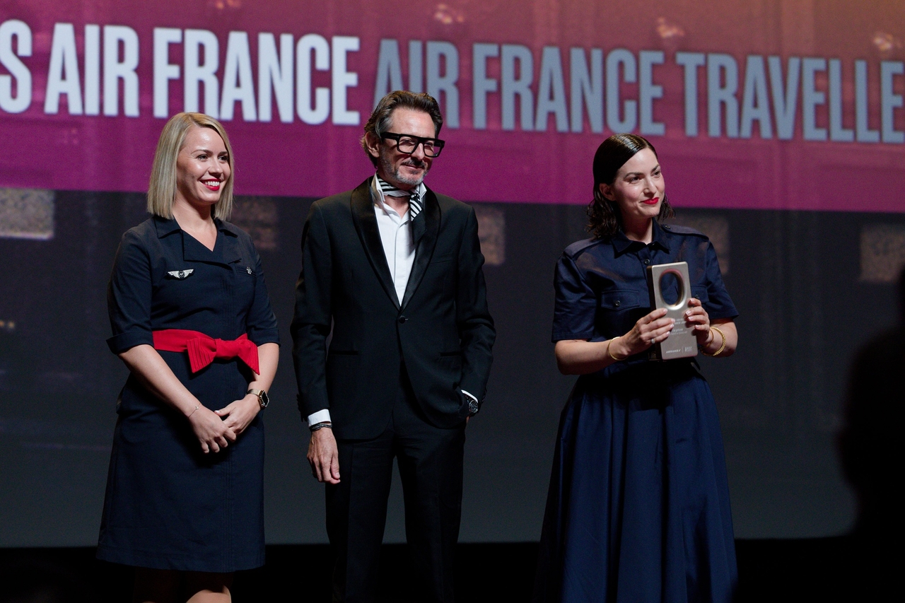 Fabien Pelous (center), Air France's senior vice president for customer experience, poses for a photo with director Rebecca Zlotowski (far right). [Air France]