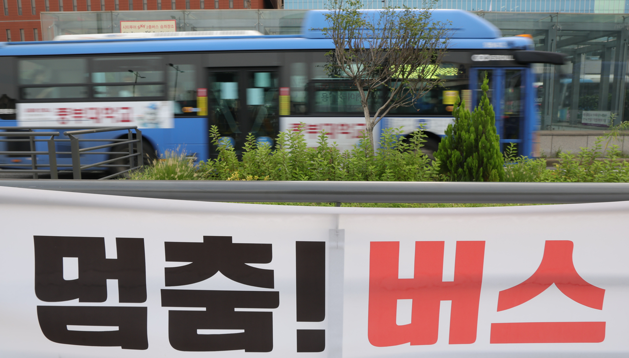 A bus strike is increasingly likely after the Seoul city bus union announced plans for industrial action on Wednesday. The union has demanded that the standard working hours for wage calculation be set at 176 hours per month with a 7.85 percent hourly pay increase, but the Seoul Bus Transport Business Association, representing management, said it cannot accept the terms. If talks collapse at the second mediation session of the Seoul Regional Labor Relations Commission on Tuesday, the union plans to launch a full strike from the first bus run on Wednesday. The photo, taken Monday morning at the Seoul Station transit hub in Jung-gu, shows buses in service.