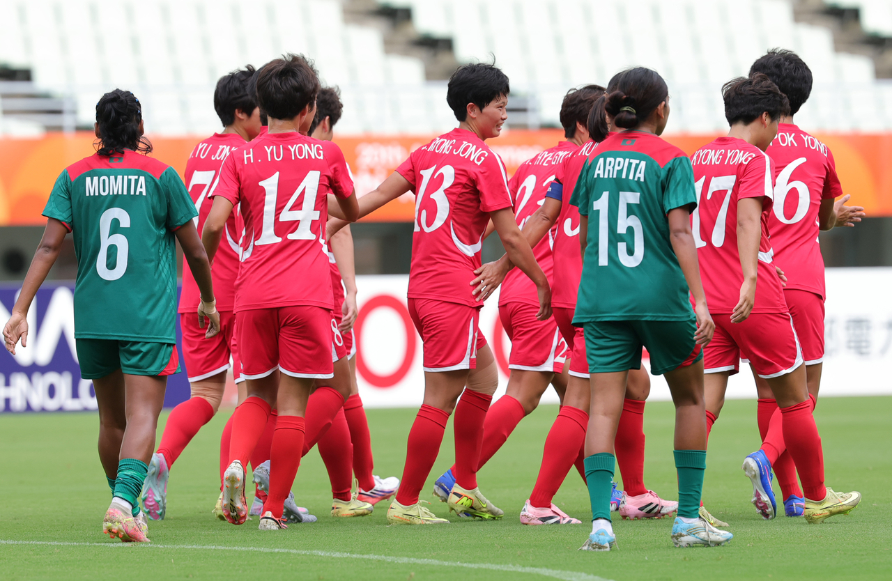 North Korean women's soccer players celebrate after score against Bangladesh on Monday at the Yanmar Stadium Nagai in Osaka, Japan. (Yonhap)