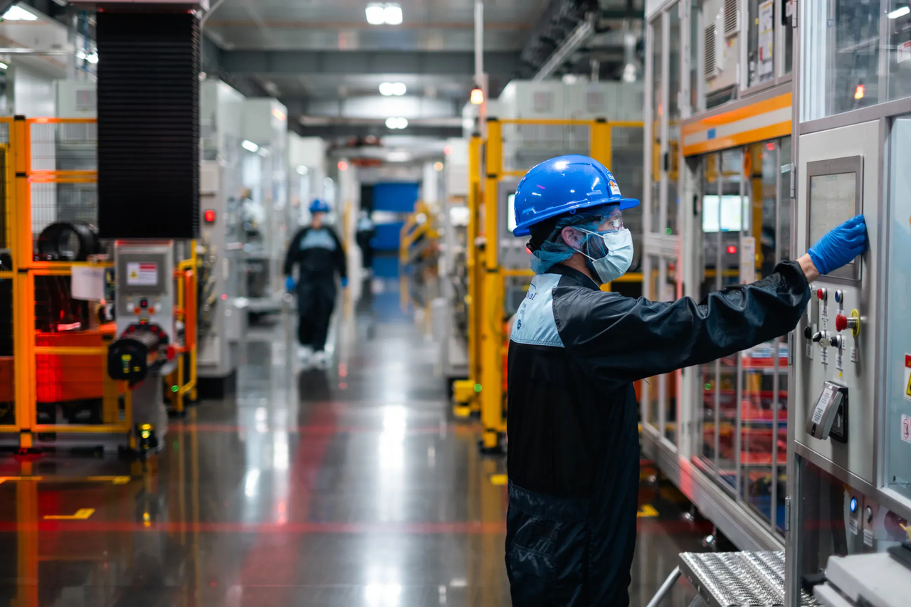 An employee inspects equipment at BlueOval Battery Park Michigan. (Ford)