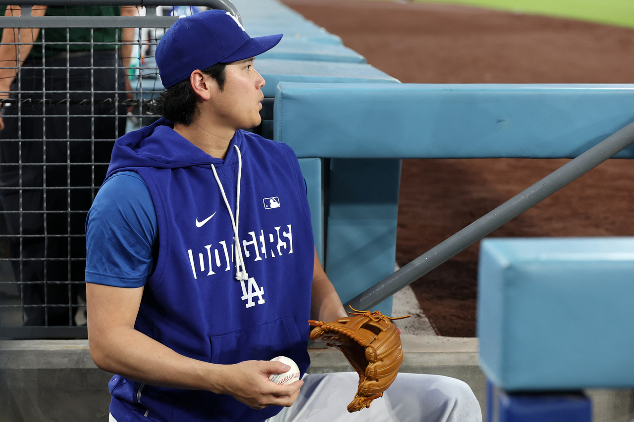 Los Angeles Dodgers' Shohei Ohtani watches a game from the dugout, at Dodger Stadium in Los Angeles, Sept. 9.   (Reuters-Yonhap)
