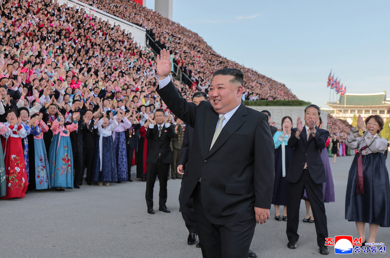 North Korean leader Kim Jong-un poses for a group photo with participants of the 15th National Conference of Teachers on Sept. 4, according to the state-run Korean Central News Agency the following day. (KCNA-Yonhap)