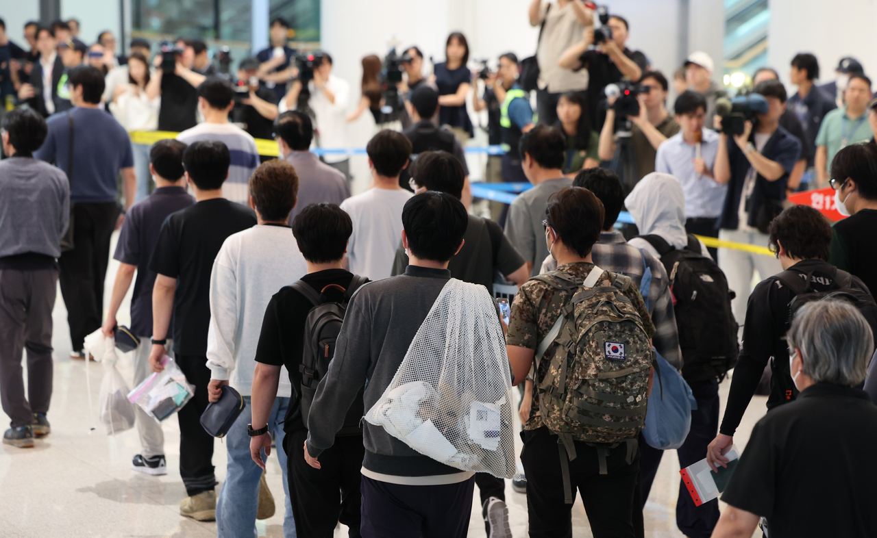 South Korean workers detained in a US immigration raid at a Hyundai Motor–LG Energy Solution battery plant in Georgia leave the arrival hall at Incheon International Airport on Sept. 12, 2025, after being released and returning home. (Im Se-joon/The Korea Herald)