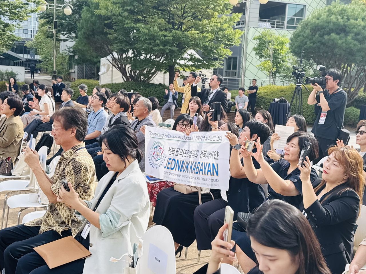 Fans and supporters of Filipino singer Dorado, runner-up on “Sing Again 4,” cheer during the opening of the ASEAN Hall's inaugural exhibition in Jeonju, North Jeolla Province, on Thursday. (Sanjay Kumar/The Korea Herald)