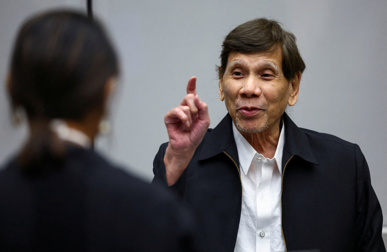 Former Philippines president Rodrigo Duterte (right) appears before the International Criminal Court, in The Hague, Netherlands, Wednesday.    (Reuters-Yonhap)