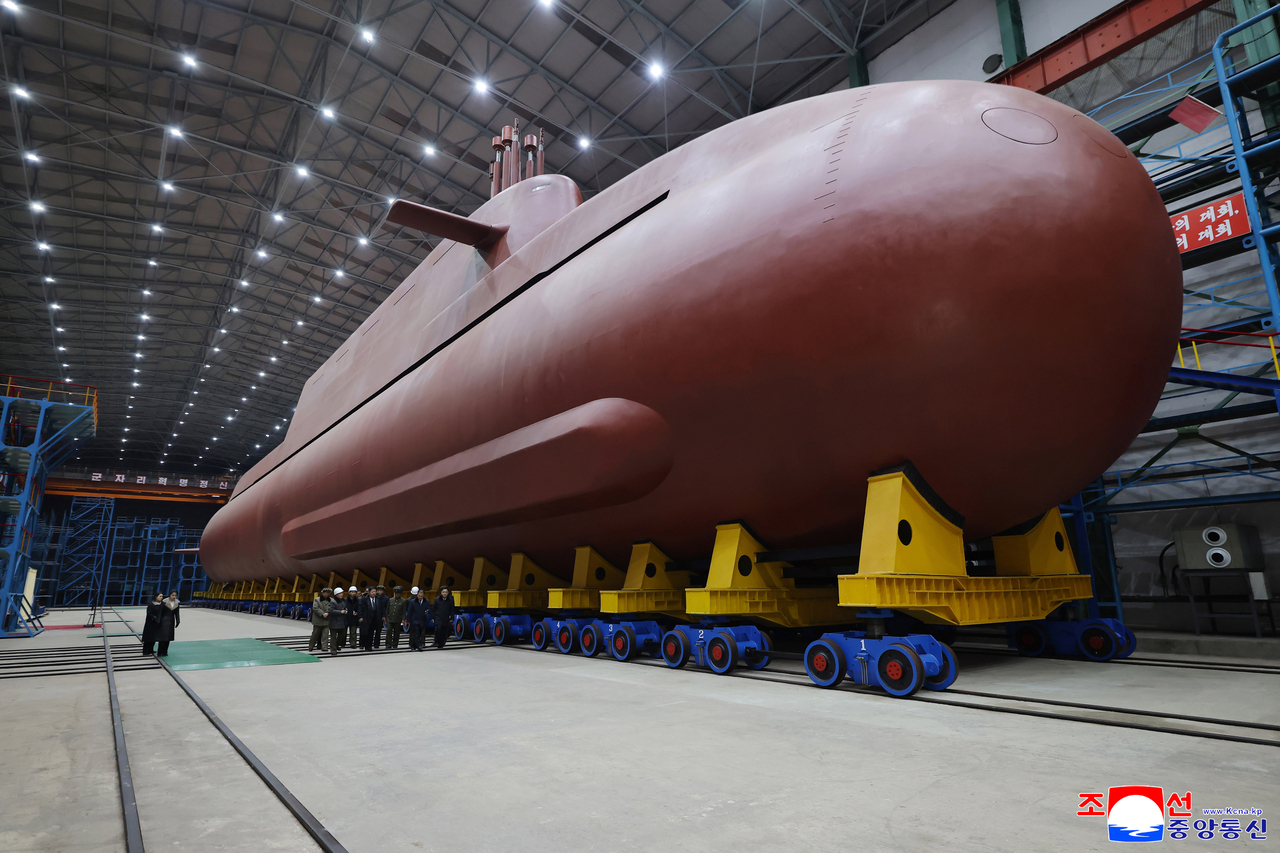 This photo, published by the Korean Central News Agency, shows an 8,700-ton nuclear-powered strategic guided missile submarine under construction. North Korean leader Kim Jong-un has inspected its building site, according to the news agency. (KCNA-Yonhap)