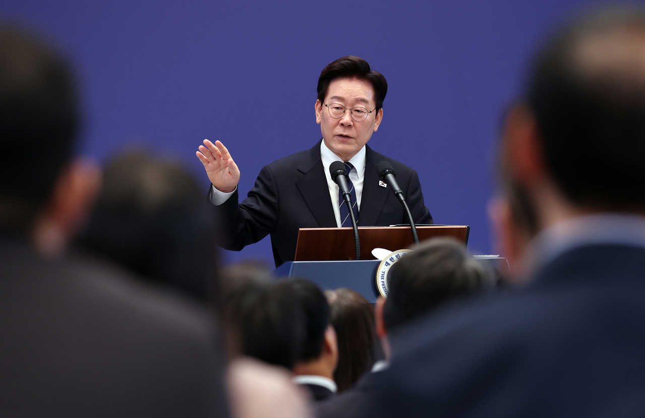 President Lee Jae Myung answers questions from reporters during a news conference at Cheong Wa Dae on Friday. (Yonhap)