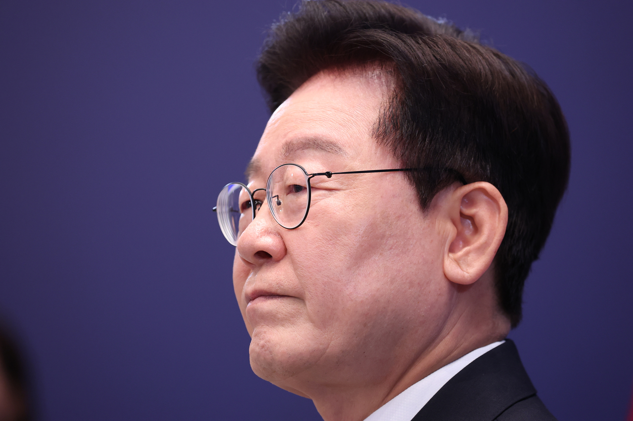 President Lee Jae Myung listens to a reporter’s question during a news conference at Cheong Wa Dae on Friday. (Yonhap)