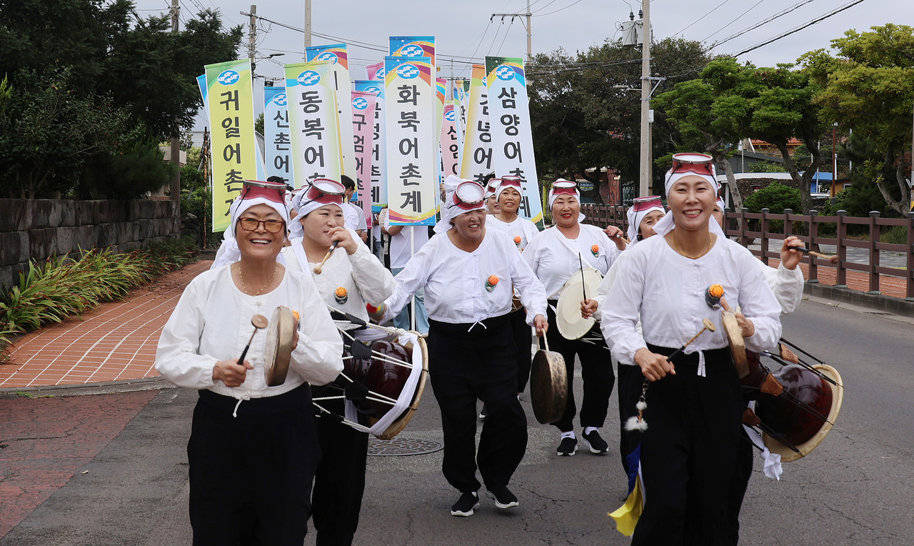 Jeju haenyeo take part in a street parade near the Jeju Haenyeo Museum in Jeju City on Saturday, the opening day of the 19th Jeju Haenyeo Festival. (Yonhap)