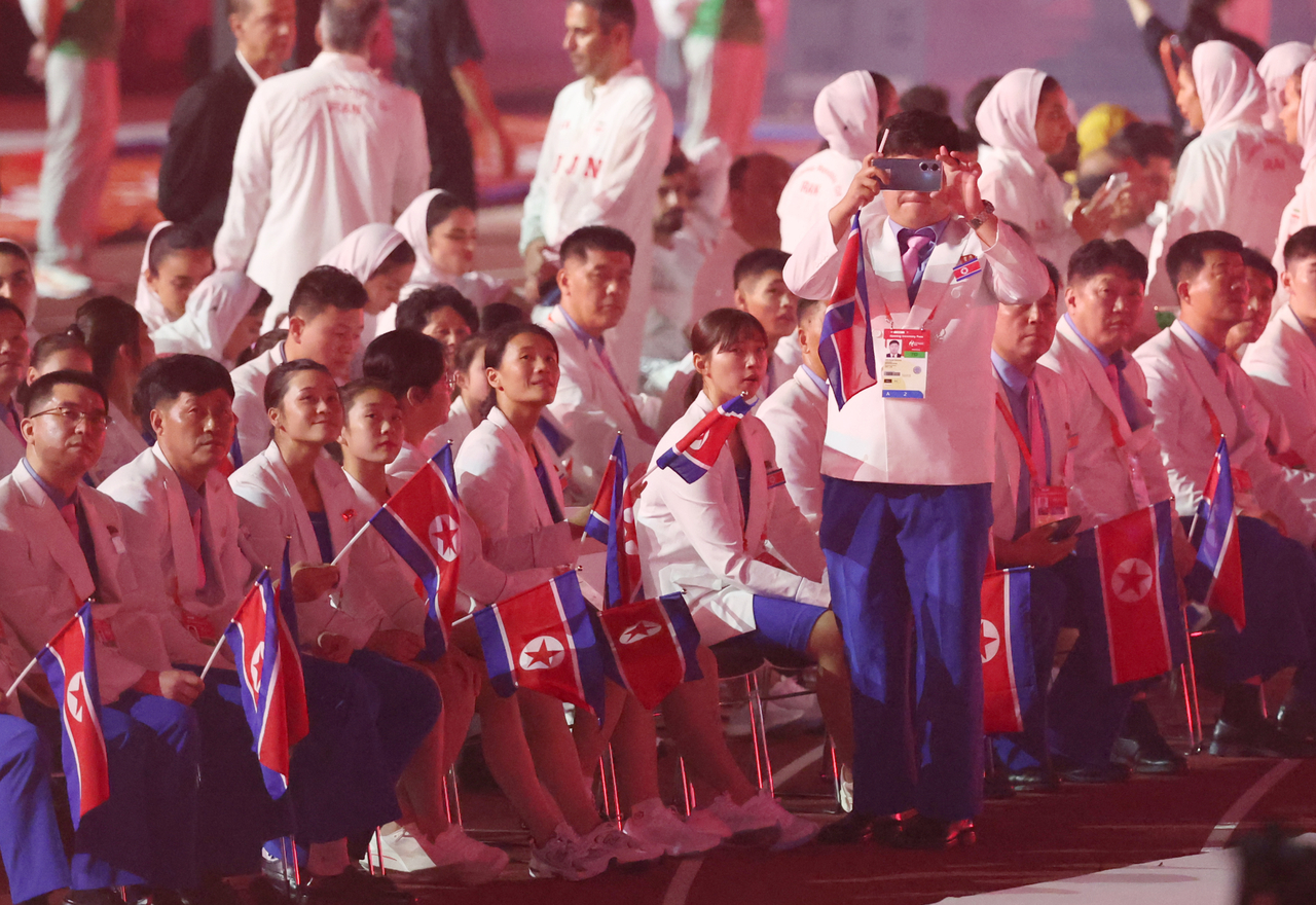 North Korean athletes sit in the stands after marching into the opening ceremony of the 2026 Aichi-Nagoya Asian Games at Mizuho Park Athletic Stadium in Nagoya, Japan, on Saturday. [Yonhap]