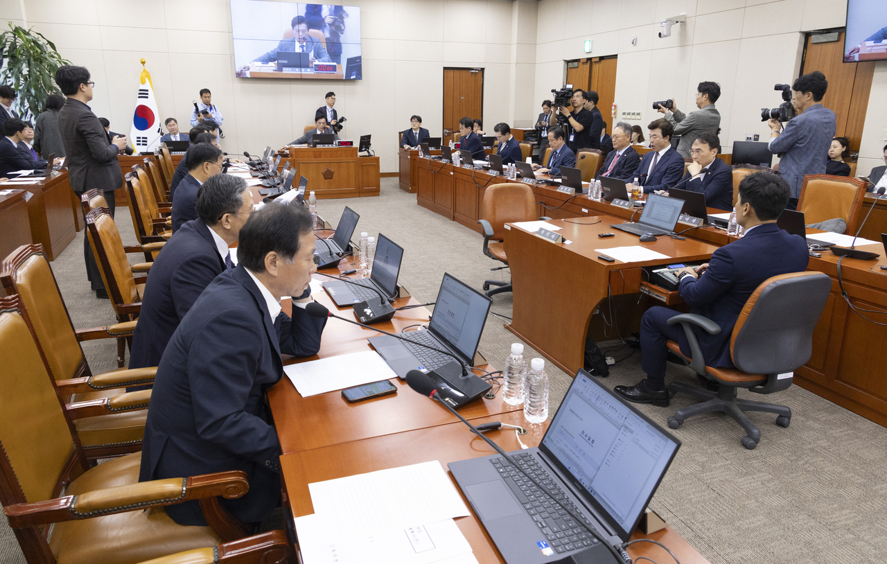 Ruling and opposition lawmakers discuss the government's postponement of a closed-door briefing on US-bound investment projects during a plenary meeting of the National Assembly's finance committee on Thursday. (Yonhap)