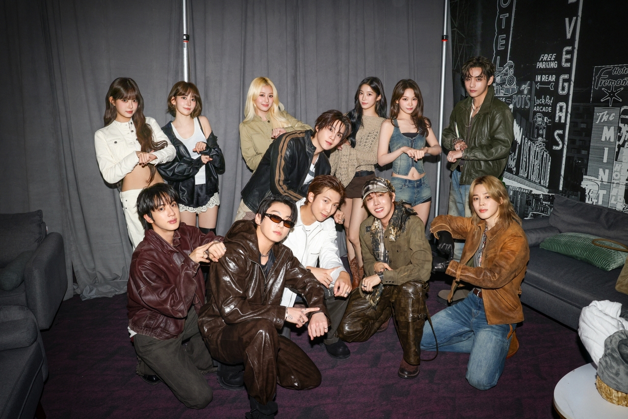 BTS and Le Sserafim pose for a photo backstage at the iHeartRadio Music Festival held in Las Vegas at T-Mobile Arena on Friday and Saturday. (Source Music)