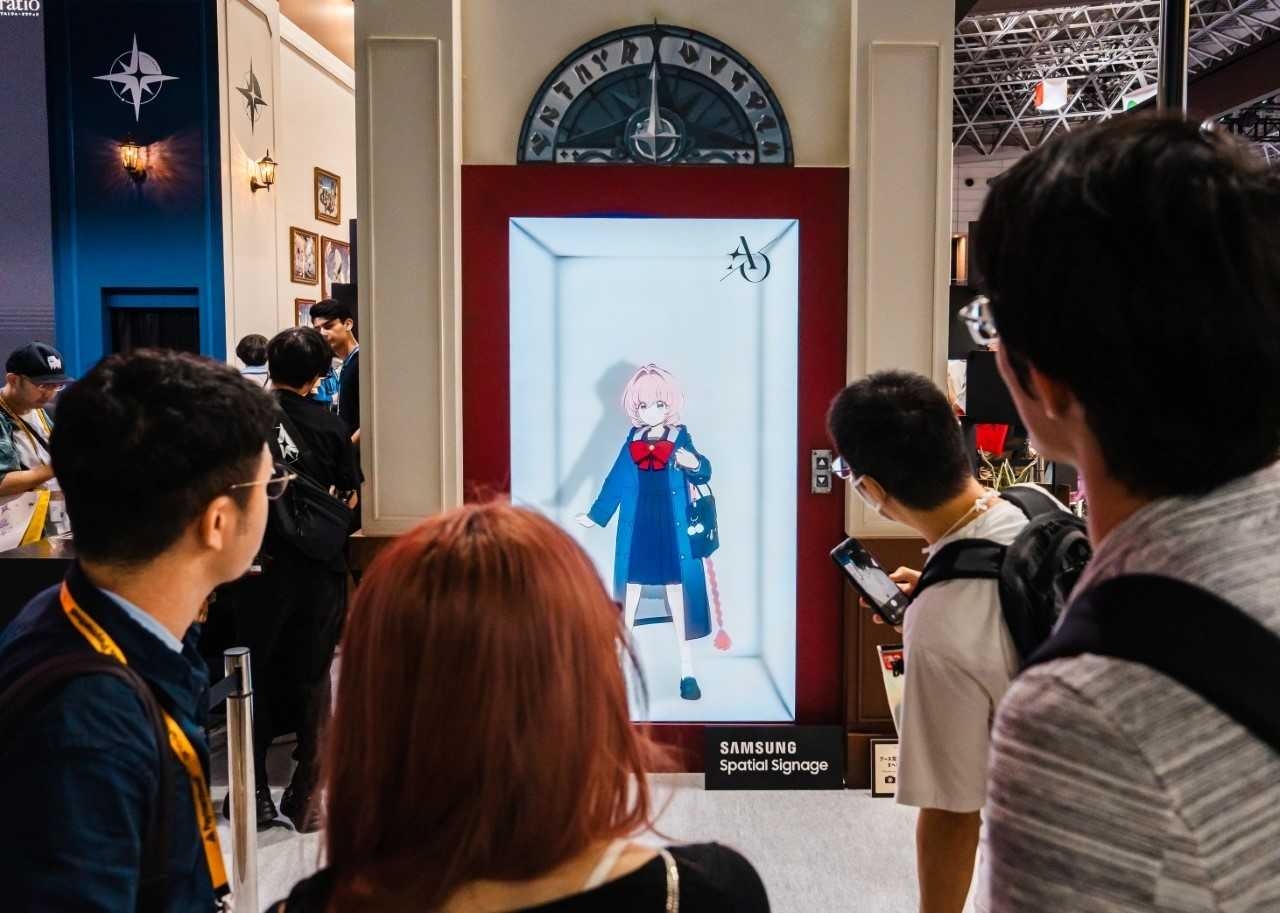 Samsung Electronics’ glasses-free 3D Spatial Signage displays a character from NC’s upcoming game Astrae Oratio at the entrance to the developer’s booth at Tokyo Game Show 2026 in Chiba, Japan. The screen recreates an in-game elevator, making the character appear to step forward into the venue. (Samsung Electronics)