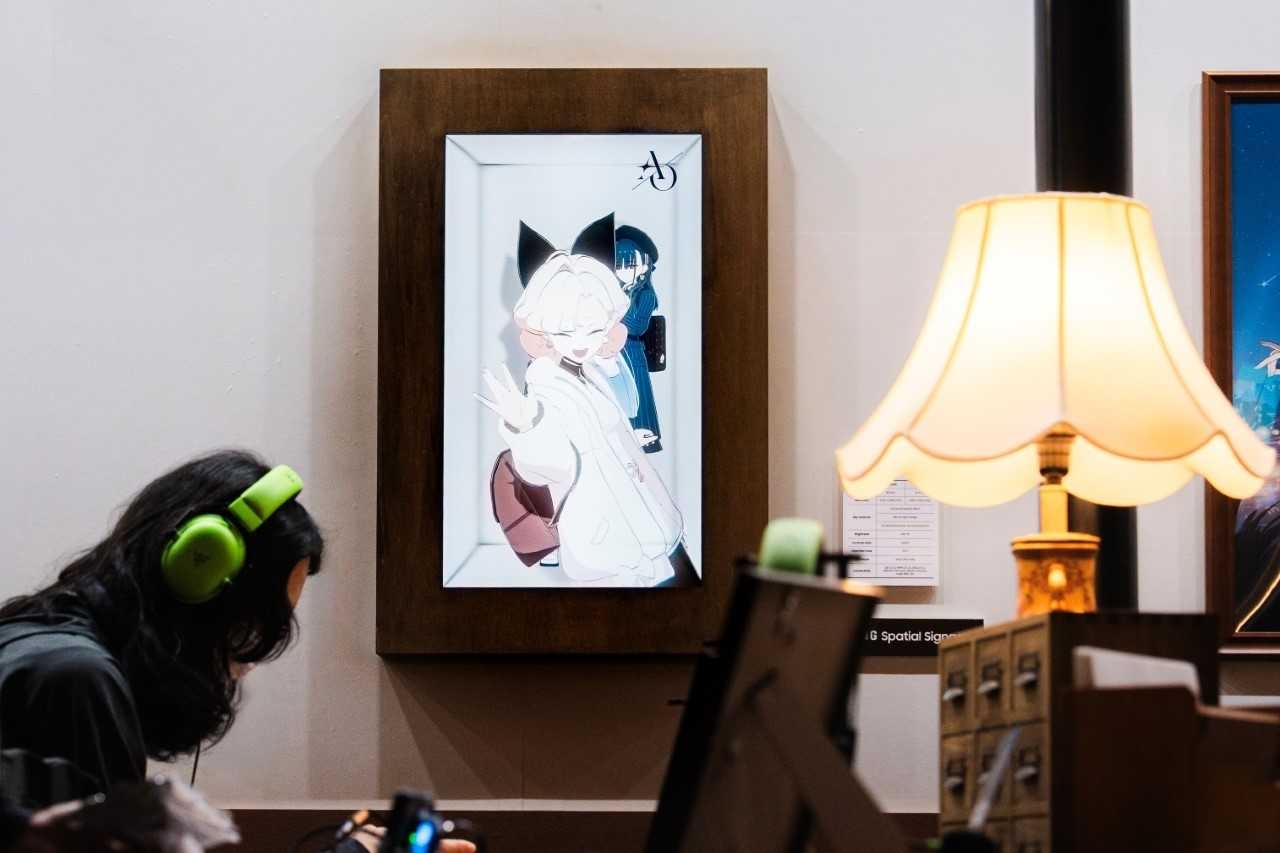 Samsung Electronics’ 32-inch Spatial Signage display is mounted like a picture frame in the lounge at NC’s Tokyo Game Show 2026 booth. The displays’ 49.4-millimeter profile allows wall installation without obstructing visitor traffic. (Samsung Electronics)