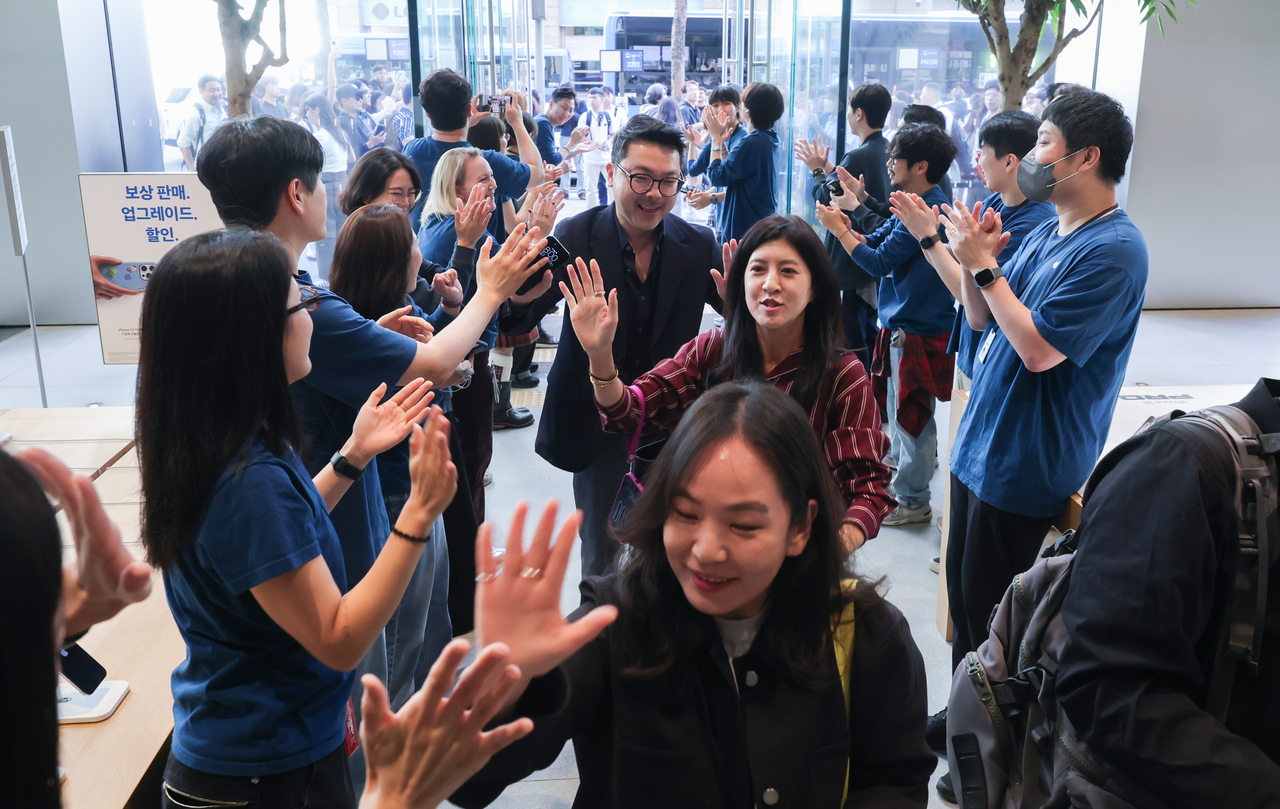 Customers file into Apple Myeongdong in central Seoul on Friday morning to pick up their new iPhones as the iPhone 18 series officially goes on sale in Korea. (Yoon Chang-bin/The Korea Herald)