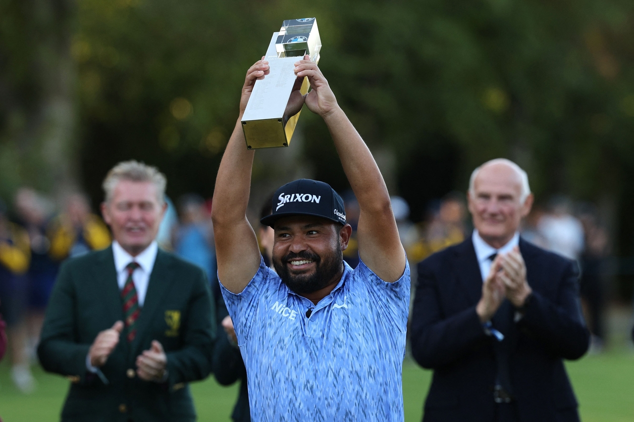 J.J. Spaun celebrates with the winner's trophy. [AFP]