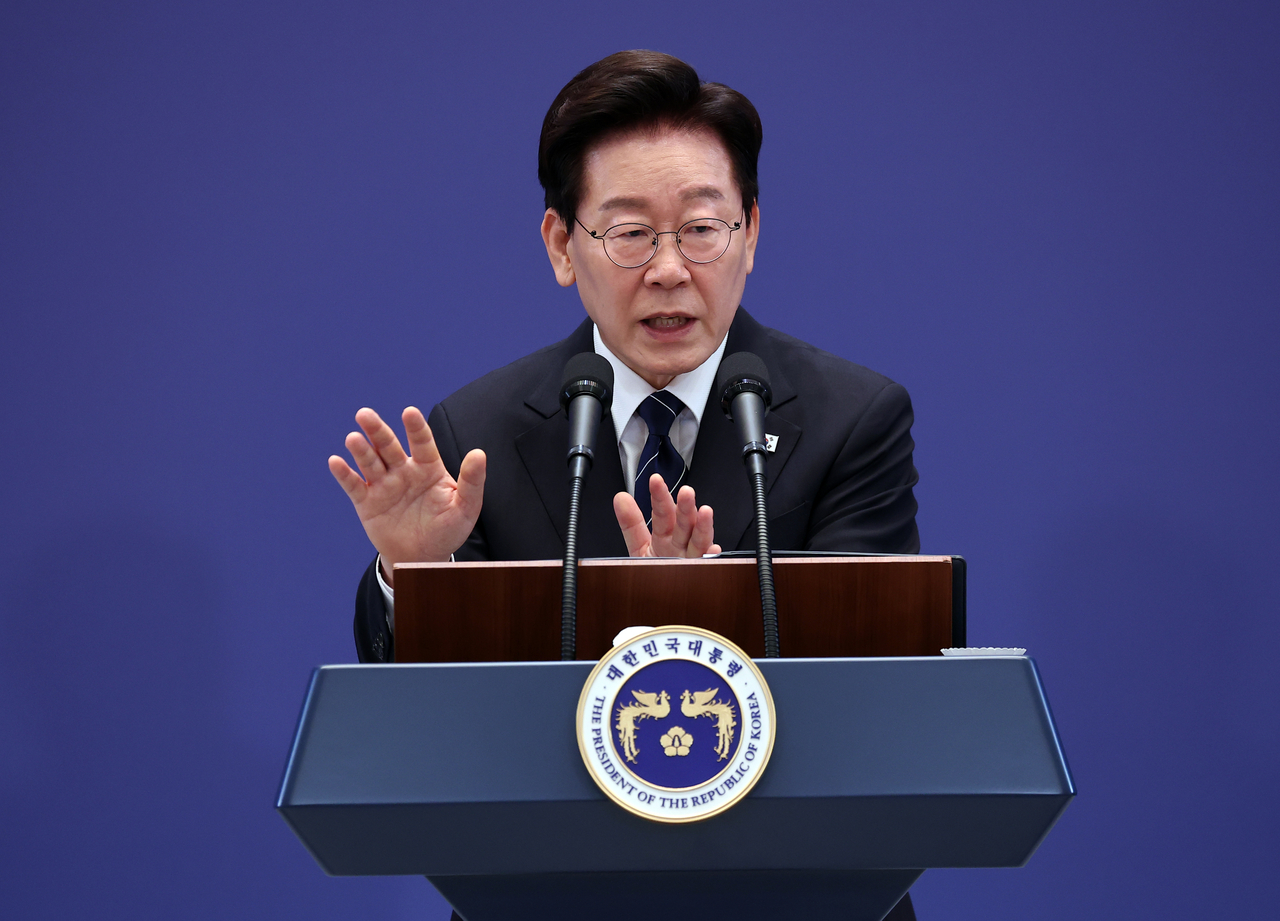 President Lee Jae Myung answers reporters' questions at a press conference held at Cheong Wa Dae's banquet hall on Friday.