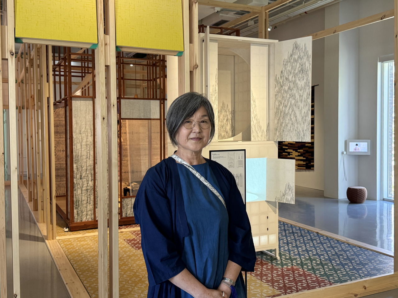 Designer Chang Eung-bok stands in front of "House in a House" at her exhibition "Equinox" on Monday. (Cha Min-jung/The Korea Herald)