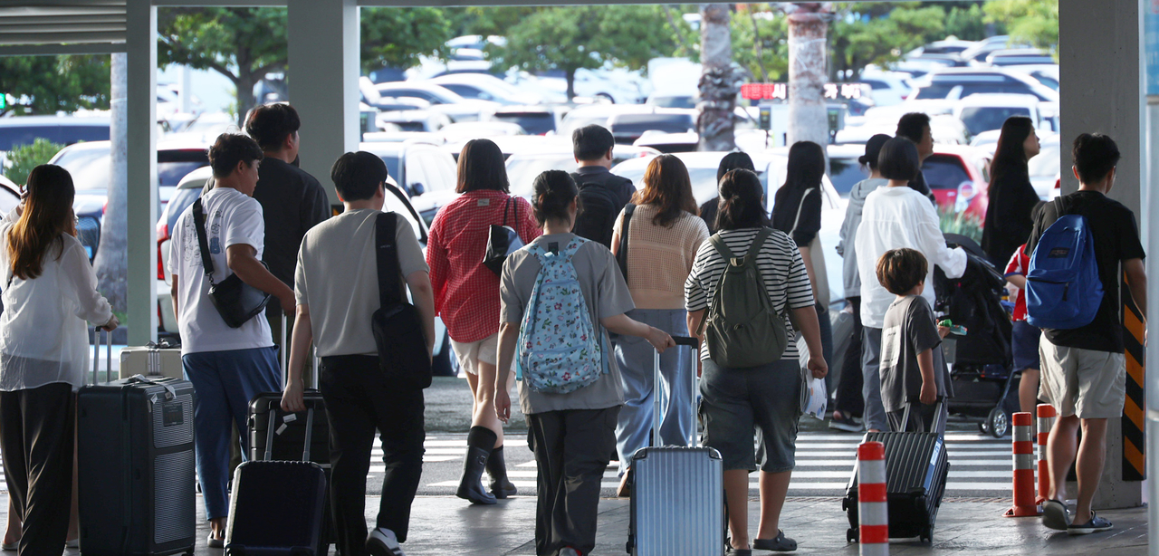 People carry their luggage at Jeju International Airport on Aug. 30. (Yonhap)