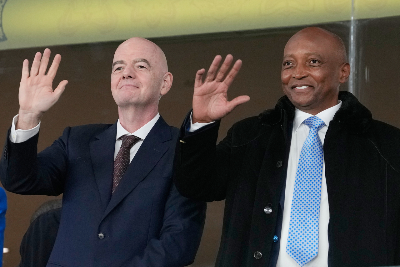 FIFA President Gianni Infantino (left) and CAF President Patrice Motsepe wave from the tribune during the Africa Cup of Nations soccer match between in Rabat, Morocco, Jan. 4.    (AFP-Yonhap)