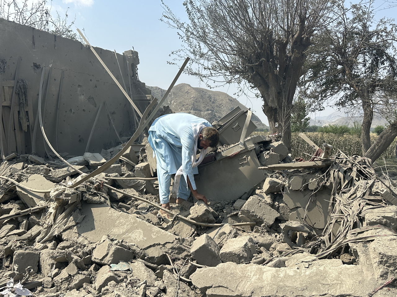 A person inspects the damage at the site of an alleged Pakistani airstrike in Noorgul district of Kunar, Afghanistan, Monday. (EPA-Yonhap)