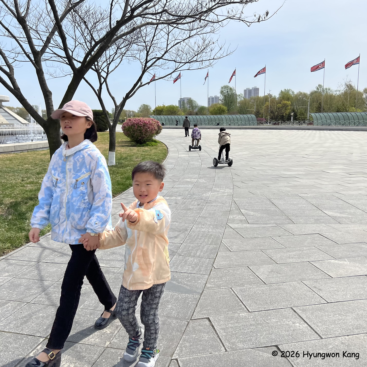 Children arrive at the Sci-Tech Complex as boys ride two-wheeled self-balancing electric scooters with handlebars in Pyongyang on April 16. (Hyungwon Kang)