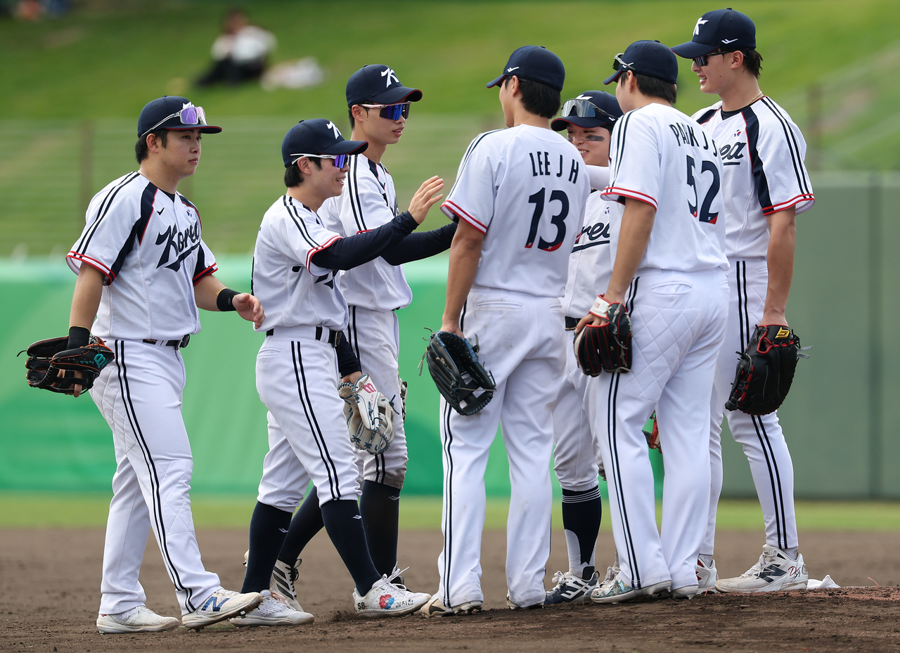 South Korean players celebrate their 18-1 win over Thailand in the teams' Group B game of the baseball tournament at the Aichi-Nagoya Asian Games at Okazaki Chuo Sogo Park Baseball Stadium in Okazaki, Japan, on Sept. 23, 2026. (Yonhap)